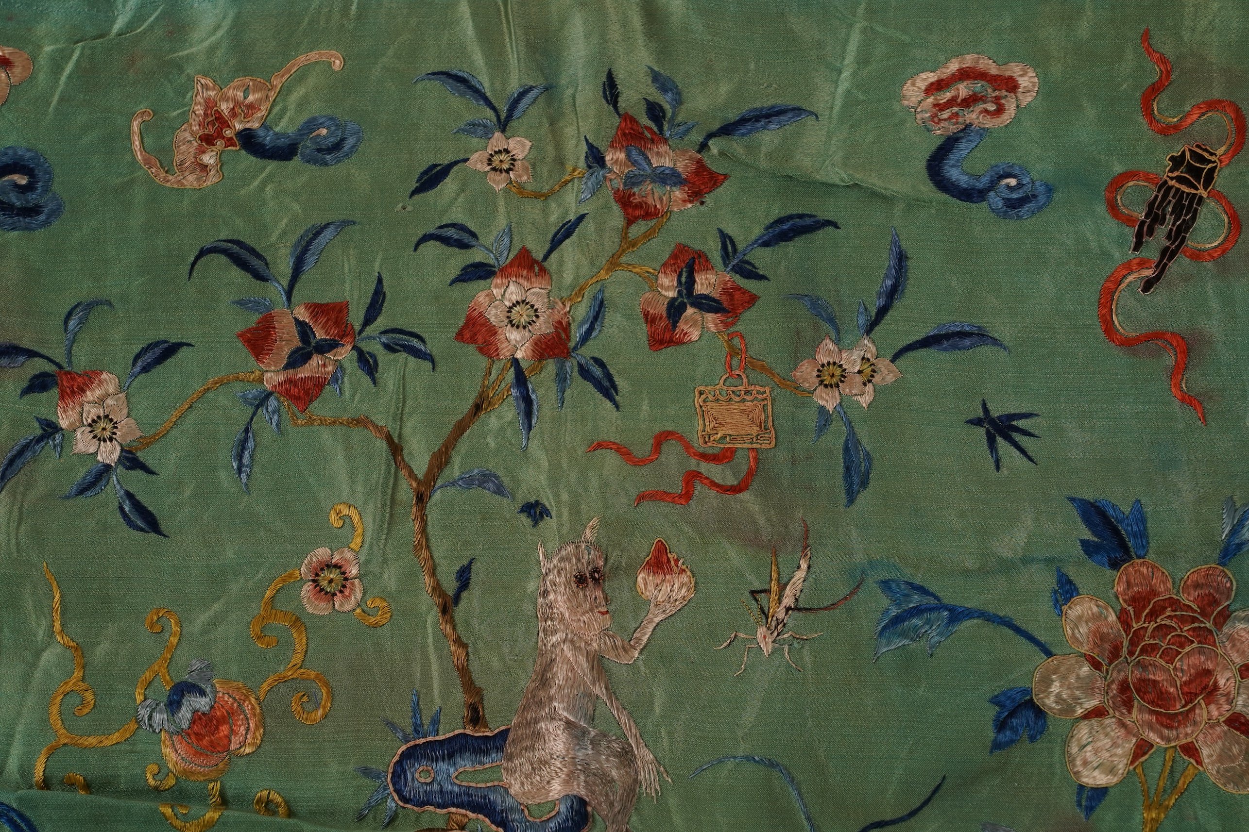 Four Chinese embroidered silk panels, late 19th/early 20th century and a similar Indian panel